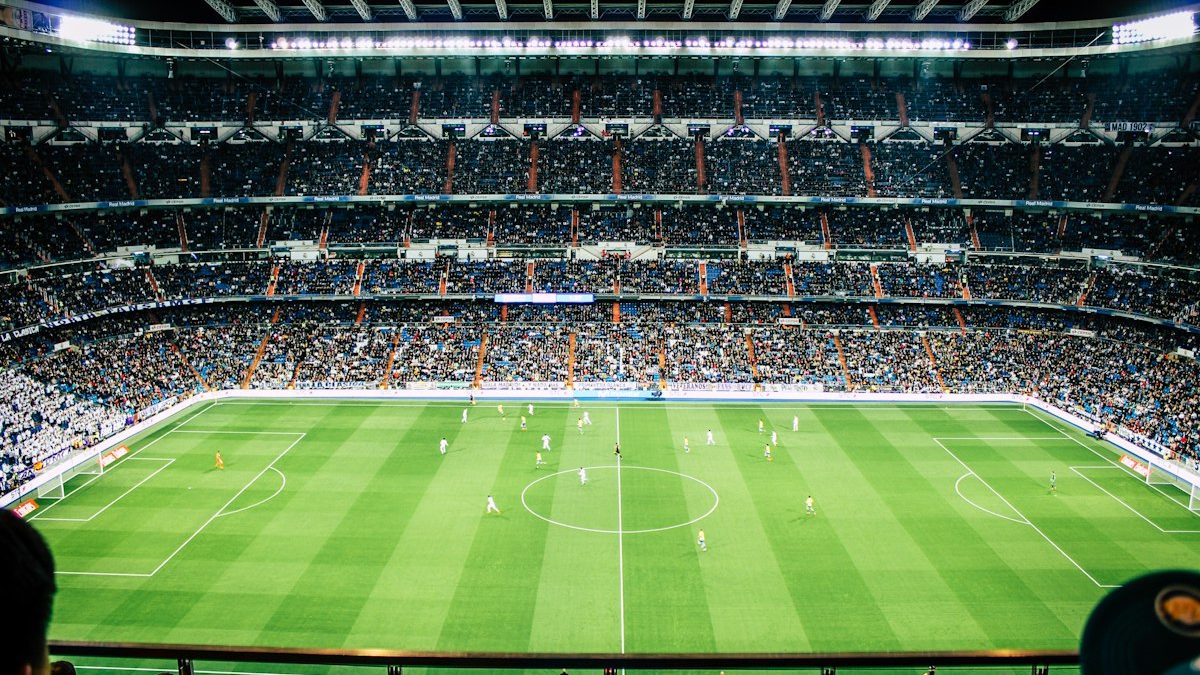 A packed stadium under floodlights on a European night
